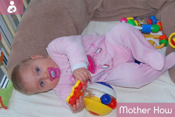 Pacifier-baby-playing-with-baby