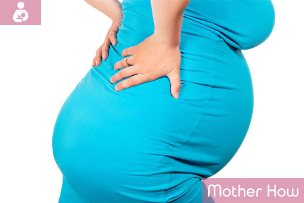 A-pregnant-women-holds-her-hands-behind-her-back