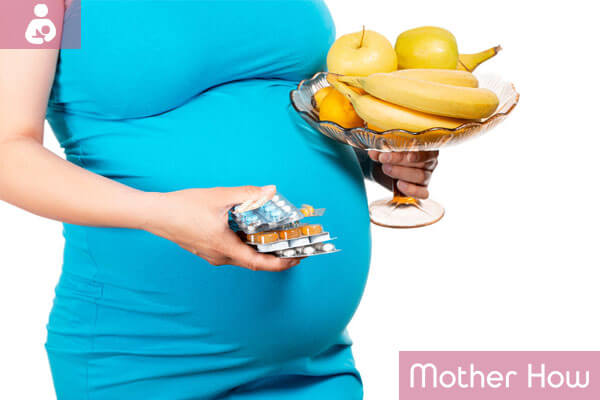 Pregnant-women-holding-pills-and-fruits